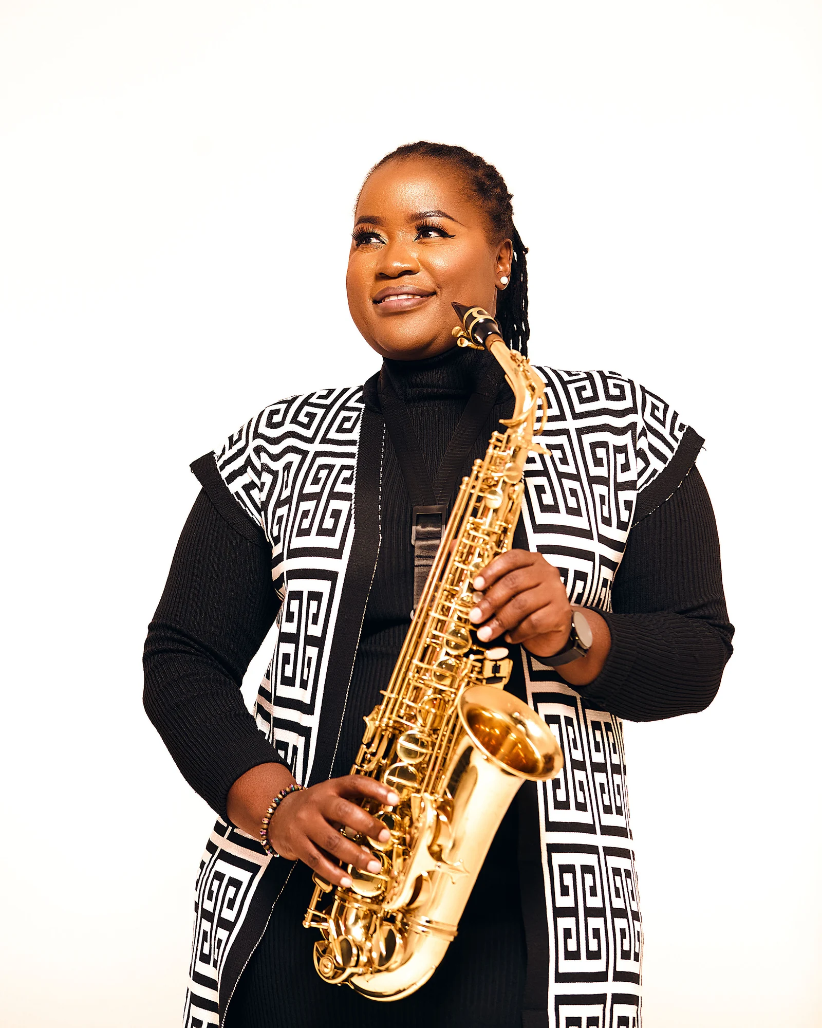 Studio portrait of Tina Watyoka holding her saxophone