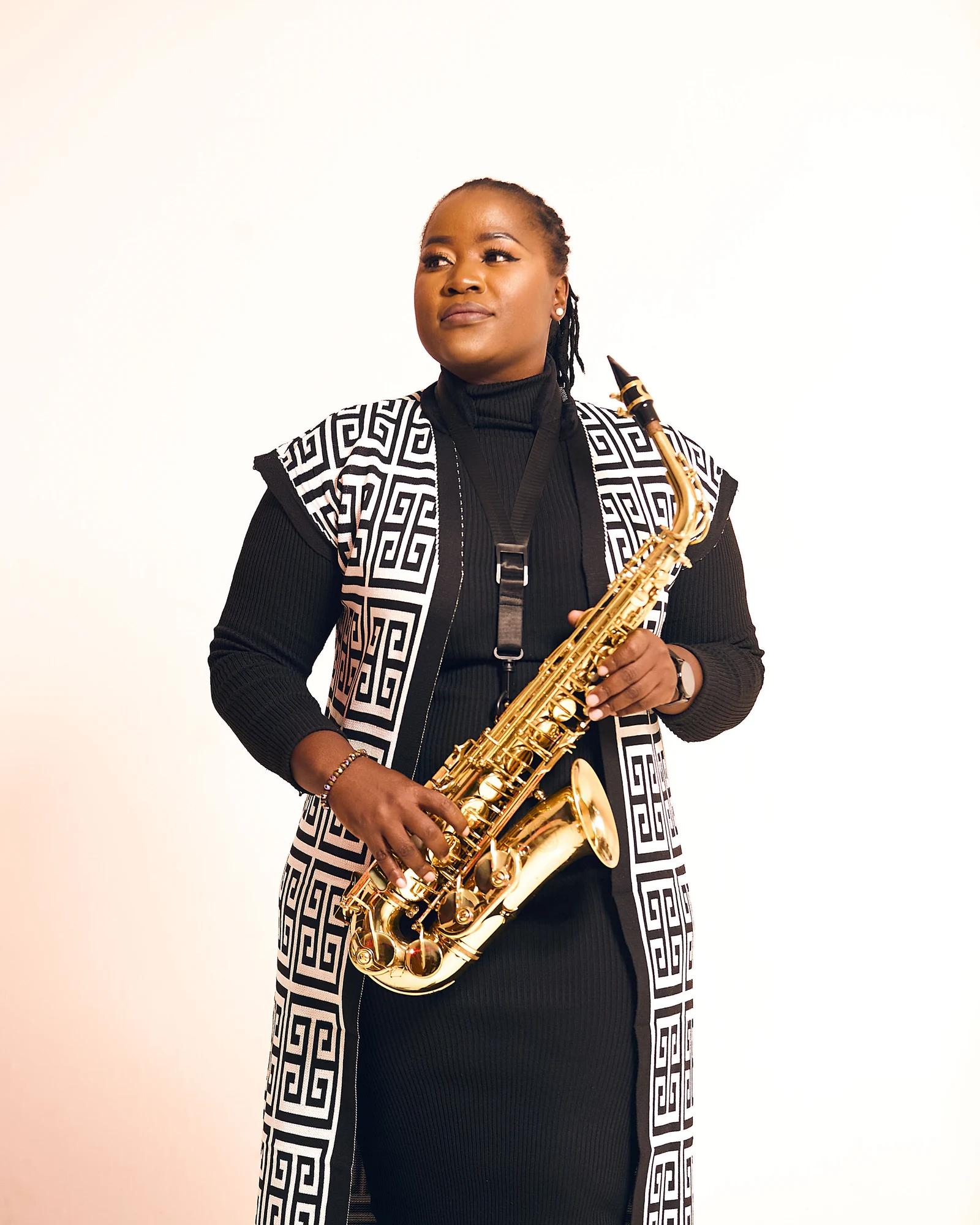 Studio portrait of Tina Watyoka holding her saxophone